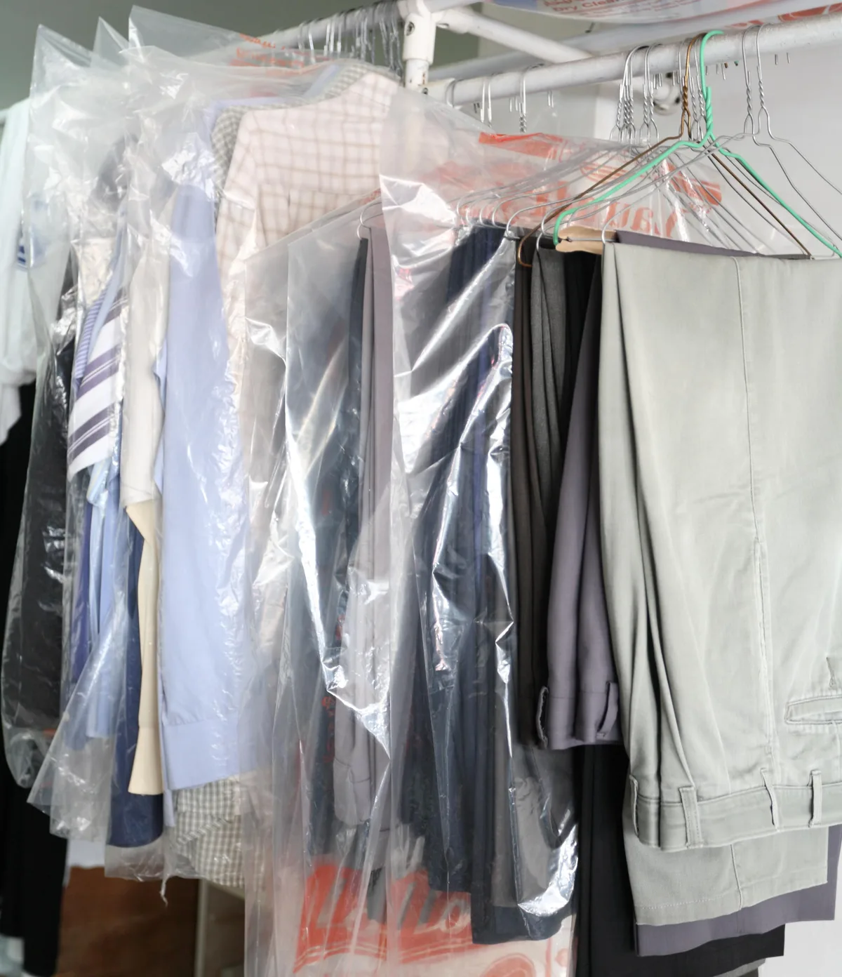 Dry-cleaned garments ready for pickup in protective bags