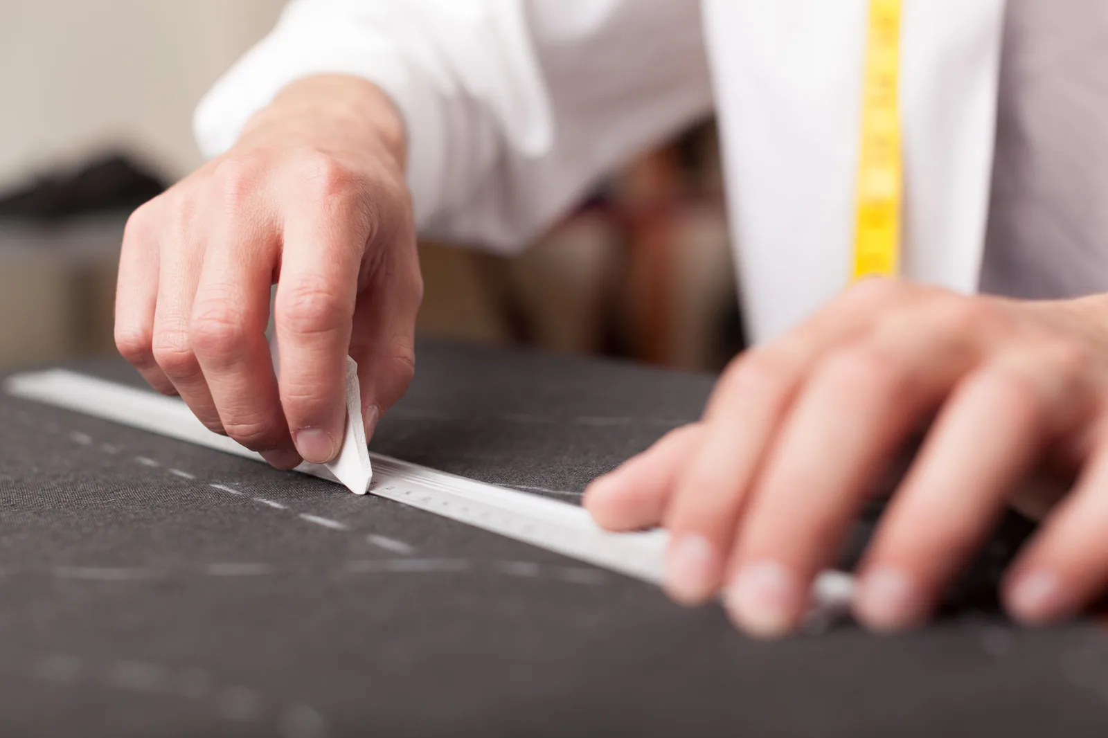 Tailor marking fabric with chalk by hand